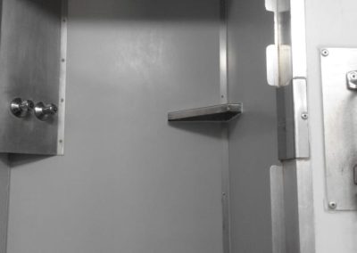 Interior of a Mobi-Shower portable shower stall showing stainless steel fittings