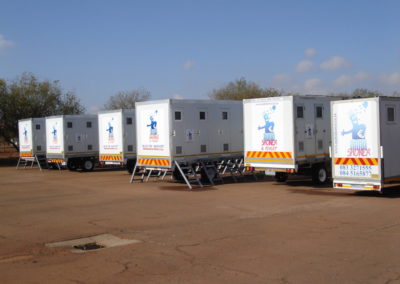 Mobi-Shower portable shower trailers set up at an outdoor event in South Africa