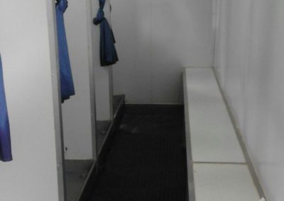 Interior of a Mobi-Shower portable shower stall showing stainless steel fittings