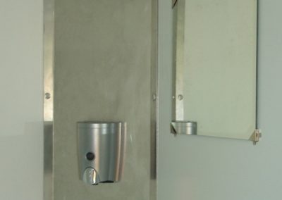 Interior of a Mobi-Shower portable shower stall showing stainless steel fittings