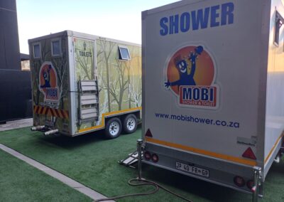 Mobi-Shower portable shower trailers set up at an outdoor event in South Africa. Portable showers and toilet hire services.