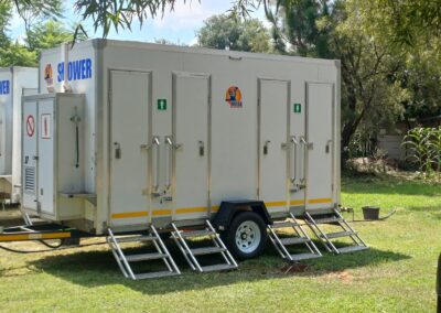 Mobi-Shower portable shower trailers set up at an outdoor event in South Africa. Portable showers and toilet hire services.