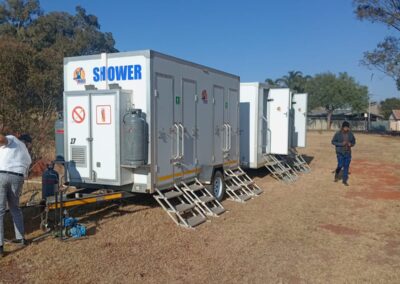 Mobi-Shower portable shower trailers set up at an outdoor event in South Africa. Portable showers and toilet hire services.