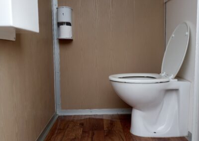 Interior of a Mobi-Shower portable shower stall showing stainless steel fittings
