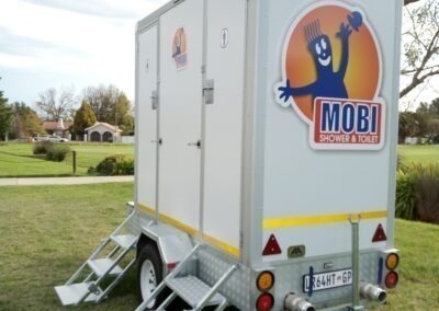 Mobi-Shower portable shower trailers set up at an outdoor event in South Africa. Portable showers and toilet hire services.